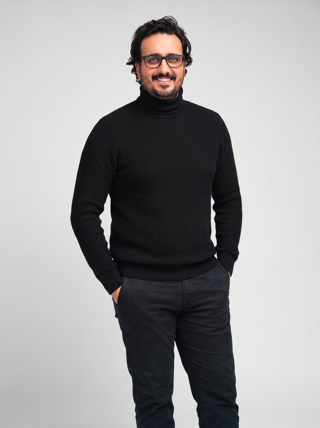 Mehul Munjani, smiling, with his hands in his pockets